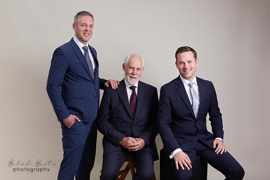 personal-brand-photographer-london-caputring-father-and-sons-in-business-dressed-in-navy-blue-suits-branding-portrait